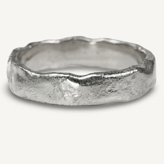 Men's 5mm wide solid platinum wedding band with a molten texture applied