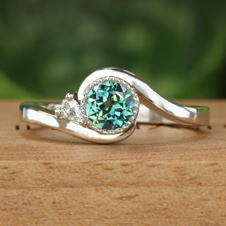 Fair trade teal green sapphire and diamond platinum wave engagement ring