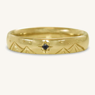 Hand engraved 4mm court men's wedding band with mountains and stars pattern. Finished with a black diamond North Star