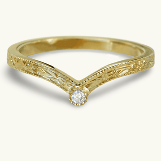 Hand engraved 18ct gold wishbone wedding ring with a solitaire diamond at the front. The band has an orange blossom floral pattern around the band