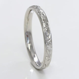 2.5mm wide court platinum wedding band with hand engraved orange blossom pattern around the band.
