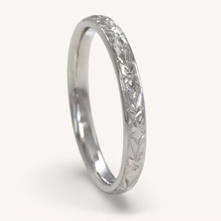 2.5mm wide court platinum wedding band with hand engraved orange blossom pattern around the band.