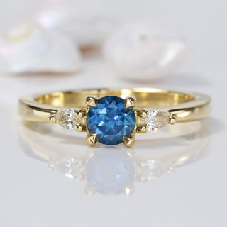 18ct gold blue sapphire trilogy engagement ring with pear cut diamonds