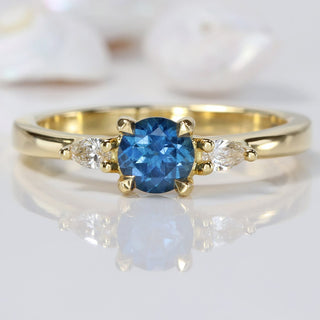 18ct gold blue sapphire trilogy engagement ring with pear cut diamonds