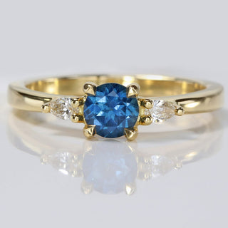 18ct gold fair trade blue sapphire trilogy engagement ring with pear cut diamonds