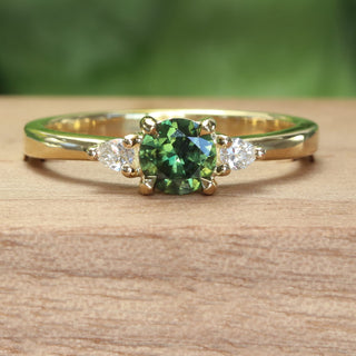 Green sapphire and pear cut diamond 18ct gold engagement ring  on wooden box