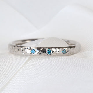 Handmade platinum hammered wedding ring with three blue diamonds, UK made.
