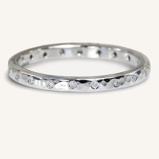 Handmade sustainable platinum slim hammered wedding band with twenty scattered diamonds set into the band