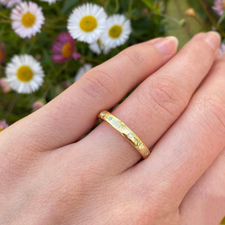 Handmade 18ct gold 3mm court wedding ring with rising suns engraved on the band