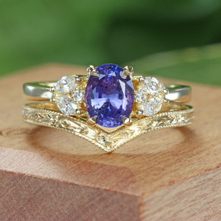 Roseland oval purple sapphire engagement ring and matching orange blossom engraved wishbone wedding ring, displayed in a handmade wooden ring box.