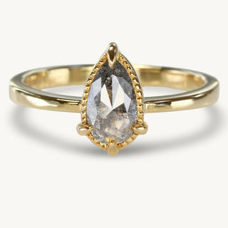 Handmade pear cut salt and pepper diamond engagement ring in 18ct gold. The diamond is held in a bezel setting with milgrain border 