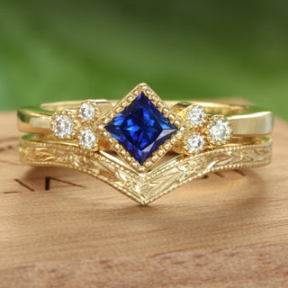 18ct gold Princess cut blue sapphire and diamond cluster engagement ring and orange blossom hand engraved wishbone wedding band