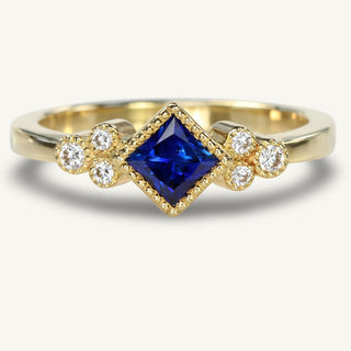 Handmade 18ct gold princess cut sapphire and diamond cluster ring with milgrain detail