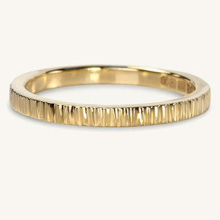 Slim hammered 9ct gold wedding band with tree bark texture applied and polished finish
