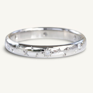 Celestial platinum wedding band with hand engraved diamond sun, moon and stars