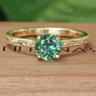 Handmade 18ct gold solitaire green sapphire ring with hand engraved floral details. 