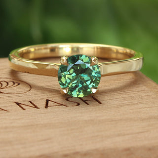 18ct gold solitaire engagement ring set with a fair trade dark green sappire