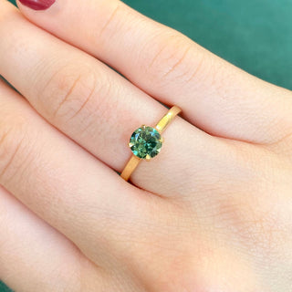 18ct gold Parti sapphire solitaire engagement ring shown worn on hand.