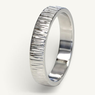Men's 4mm wide platinum wedding band with a tree bark hammered texture applied by hand and polished to reflect the light