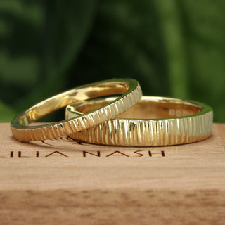 A pair of tree-bark texture gold wedding bands by Lilia Nash