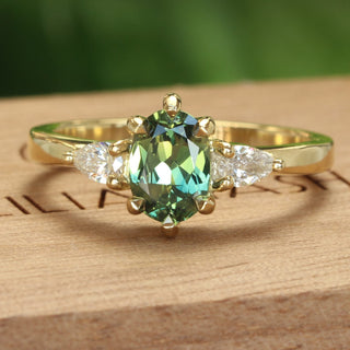 18ct gold trilogy engagement ring with a fair trade Parti sapphire and pear cut natural diamonds