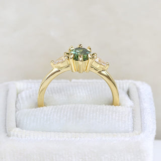 Side view of Veryan 18ct gold oval Parti sapphire and pear cut diamond trilogy ring