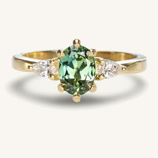Veryan oval natural green sapphire and pear cut diamond trilogy engagement ring, handmade from solid 18ct yellow gold. 