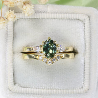 Green sapphire bridal ring set in 18ct gold, held in a velvet ring box with white flowers
