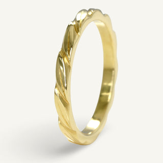 Slim 18ct gold wedding band with hand engraved leaves around the band