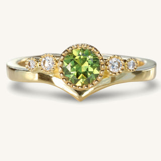 Handmade solid 18ct gold fair trade  green sapphire and diamond wishbone engagement ring. The gemstone are bezel set with pretty milgrain detail