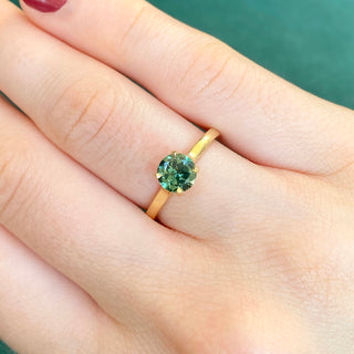 18ct gold Parti sapphire solitaire engagement ring shown worn on hand.