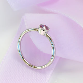 Side view of platinum pink sapphire solitaire engagement ring.