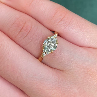 Salt and pepper diamond cluster engagement ring in 18ct gold shown worn on hand.