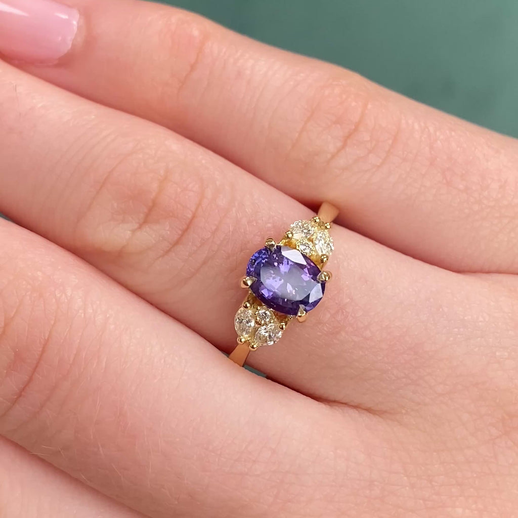 18ct gold oval purple sapphire engagement ring shown worn in a video thumbnail.