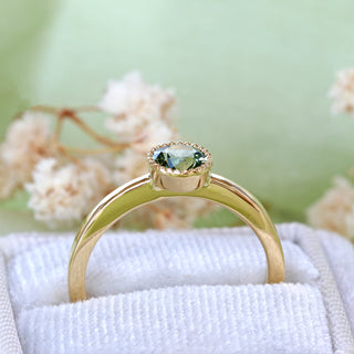 Side view of 18ct gold green sapphire solitaire engagement ring showing raised bezel setting.