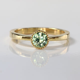 Green sapphire 18ct gold solitaire engagement ring with milgrain detail