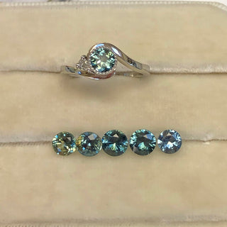 Choosing a fair trade teal sapphire to set into a wave design platinum engagement ring