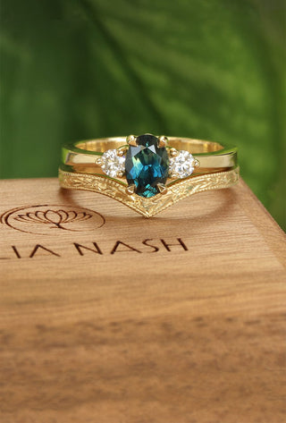 18ct gold ceep teal sapphire and diamond trilogy engagement ring and orange blossom engraved wishbone wedding band