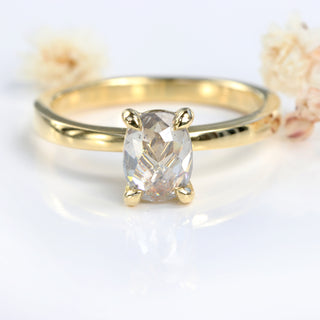 Close-up of oval rose cut salt and pepper diamond showing claw setting.