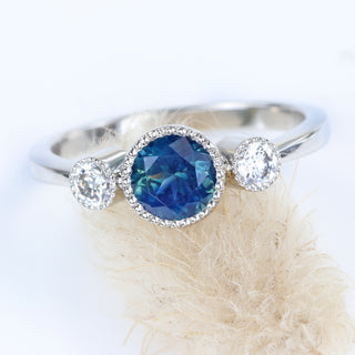 Fair trade Parti sapphire platinum ring on grass flower.