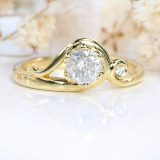 Close-up of handmade 18ct gold Art Nouveau engagement ring with icy diamond and small accent diamond.