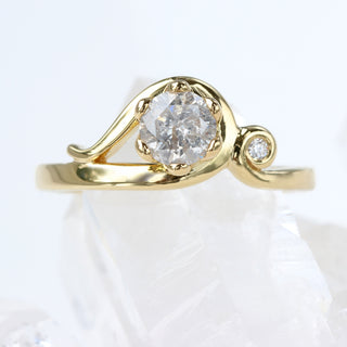 18ct gold handmade Art Nouveau engagement ring with icy diamond, angled view on neutral background.