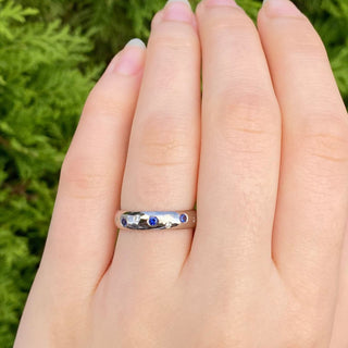 Sapphire and diamond 18ct white gold eternity or wedding ring, being worn on the hand