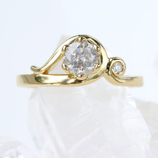 18ct gold handmade Art Nouveau engagement ring with icy diamond, angled view on neutral background.