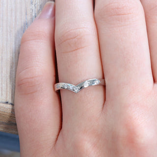 Diamond wishbone band, handmade from solid 950 platinum, being worn on the finger