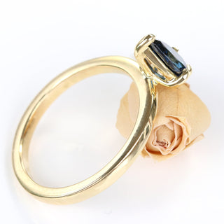 Side view of handmade 18ct gold pear cut sapphire engagement ring showing claw setting.