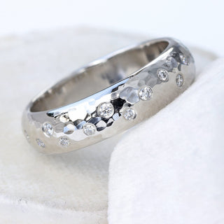 Chunky platinum wedding band with hammered finish, set with a scattering of natural diamonds