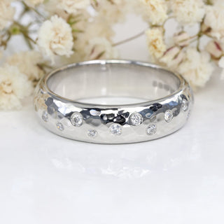 Chunky platinum diamond wedding or half eternity band with a hammered finish