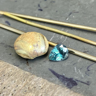 Custom Teal Sapphire and Diamond Halo Engagement Ring in 18ct Gold
