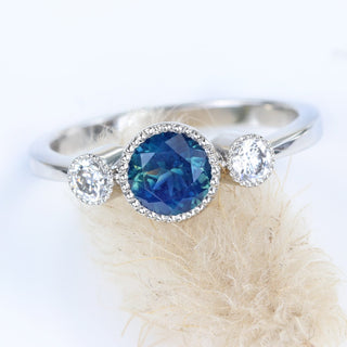 Fair trade Parti sapphire platinum ring on grass flower.